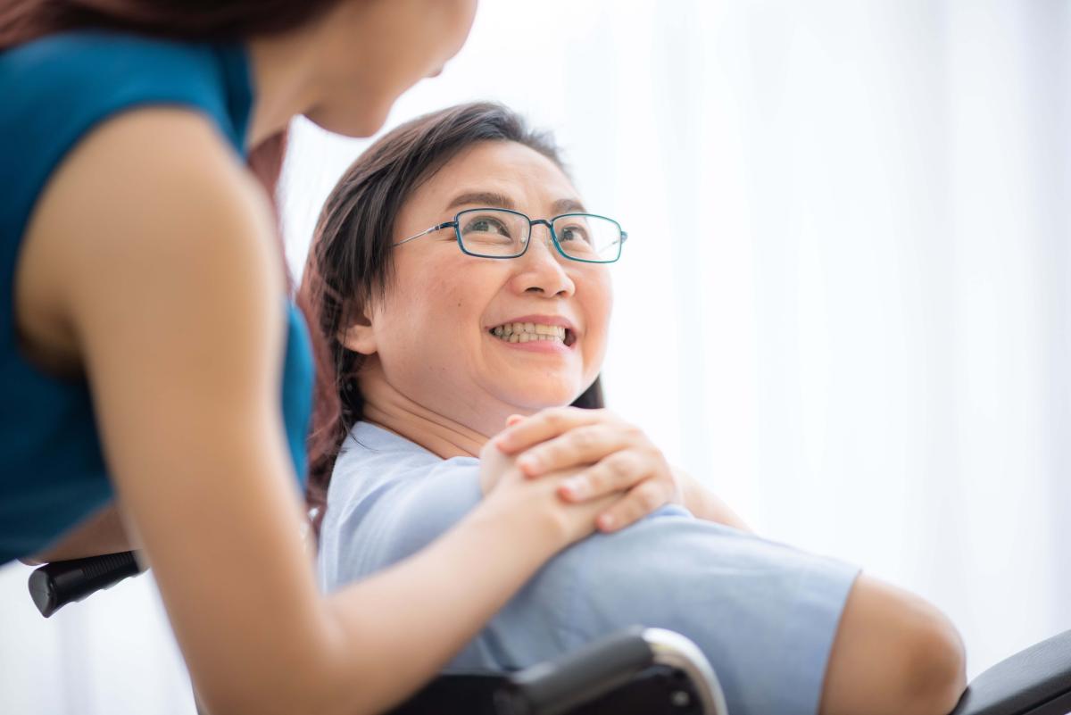 old-women-smlie-while-sitting-on-wheelchair